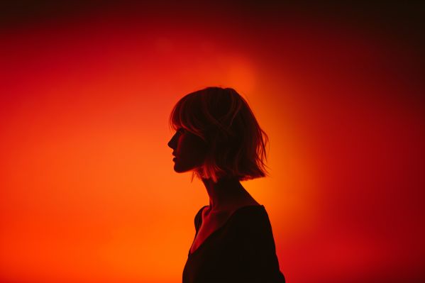 Silhouette of Young Blonde With Short Hair on Orange Background Free Image