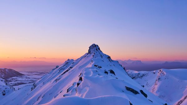 Snowy Mountain Peak with Sunrise Glow Free Stock Photo