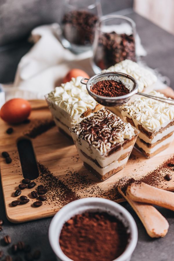 Sprinkling Cocoa Powder on Tiramisu Trifles Free Photo