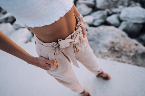 Well Dressed Woman is Standing by a Rocky Shore Free Photo