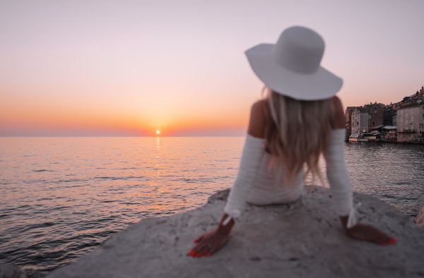 Well Dressed Woman Watching Beautiful Sunset Above the Sea Free Photo