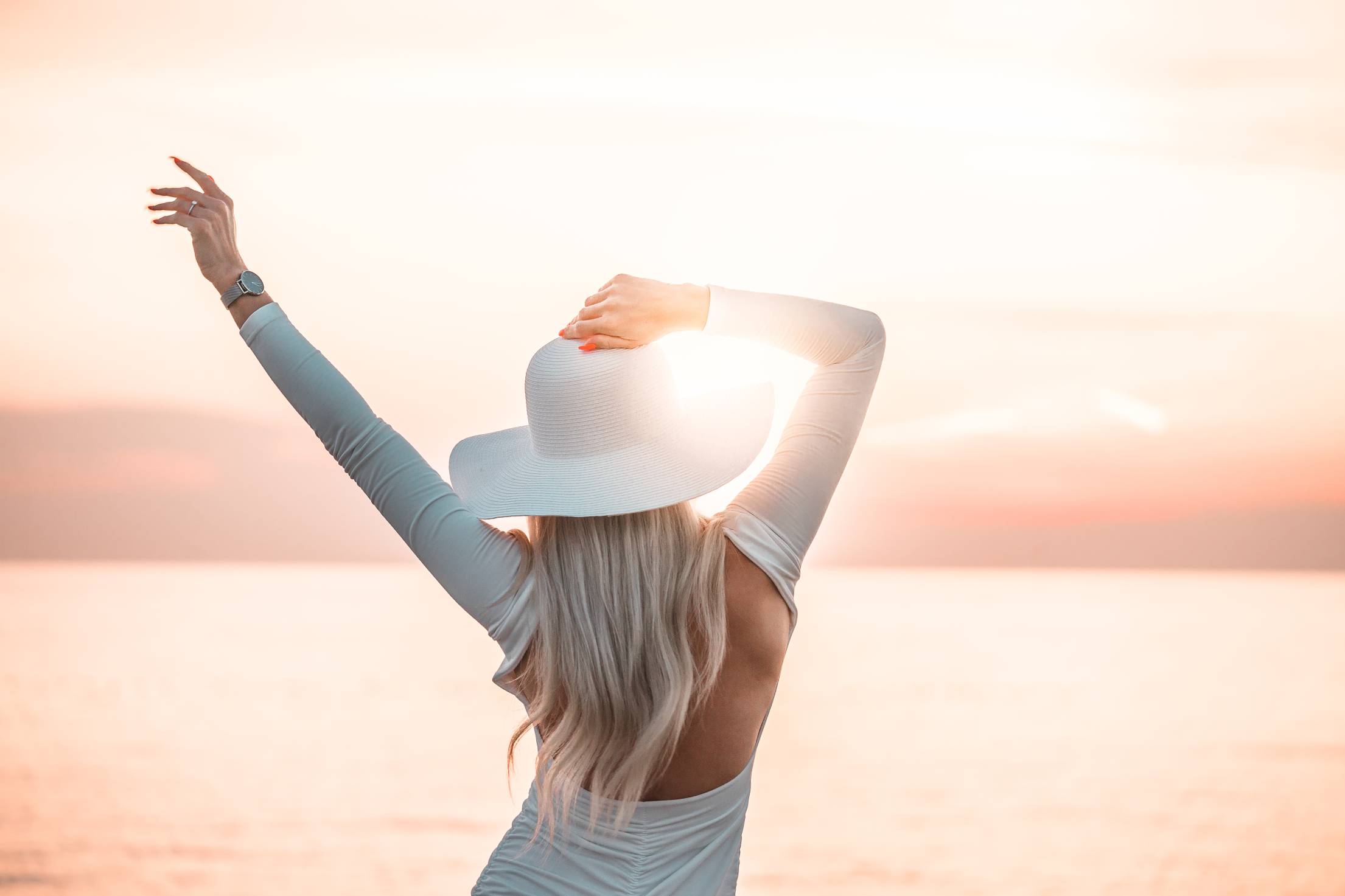 Woman Enjoying the Sunset by the Sea Free Photo