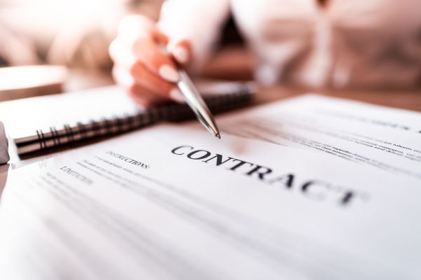 Woman Pointing at Business Contract with Silver Pen Free Photo