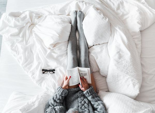 Woman Reading a Book in Bed Free Photo