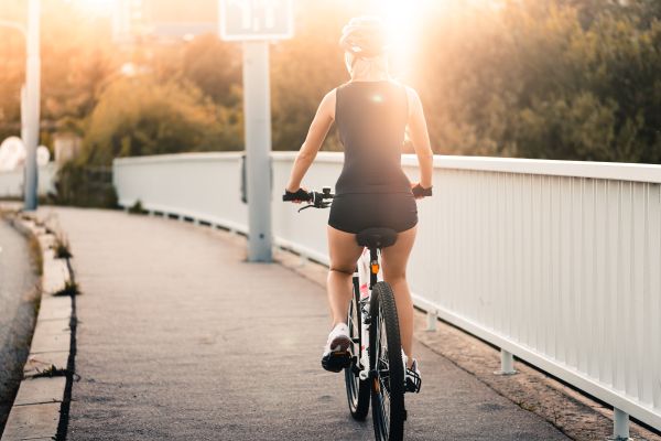 Woman Riding a Bike During Evening Sun Free Photo