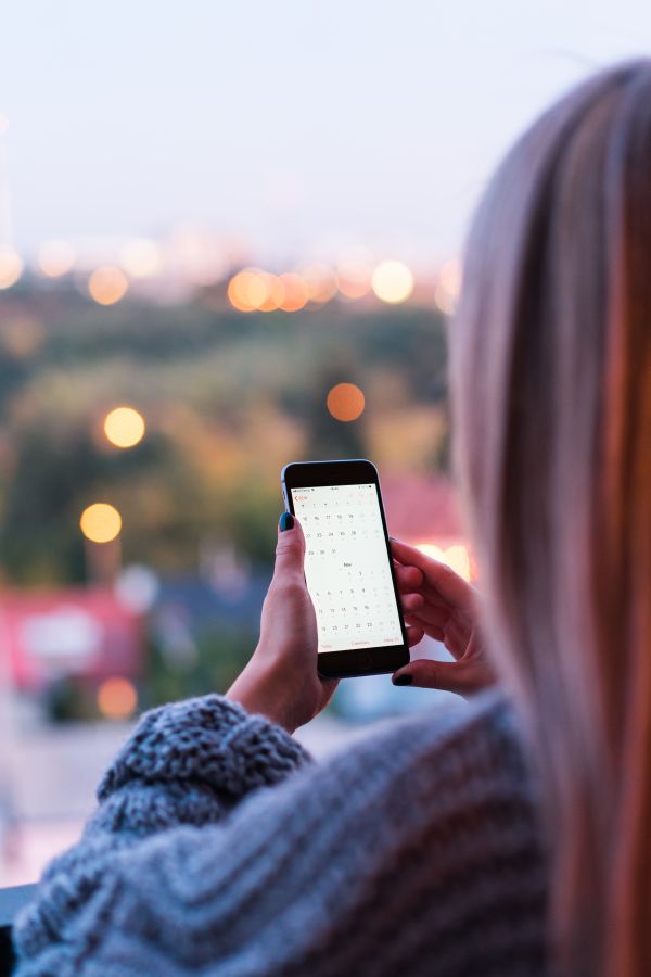 Woman Using Calendar.app on Her Smartphone Free Photo