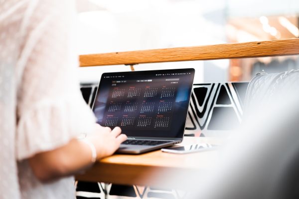 Woman Using Her MacBook in a Café Free Photo