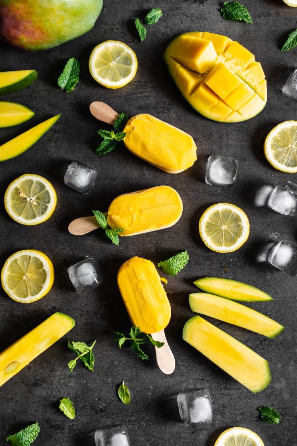 Yellow Popsicles Decorated with Mint Leaves and Fruit Free Photo