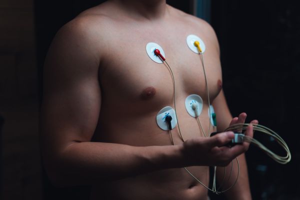 Young Man Checking His Heart With a Portable ECG Monitor Free Photo