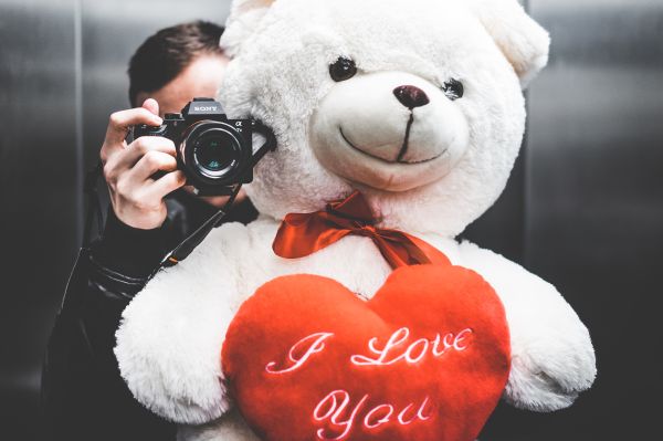 Young Man Taking Selfie with Big Teddy Bear for His Girlfriend in Elevator Free Photo