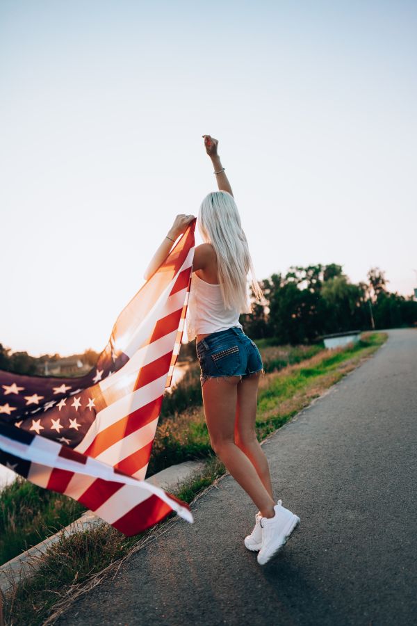 Young Woman Celebrating Independence Day with USA Flag Free Photo